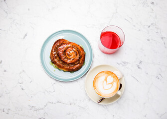 cinnamon roll breakfast with  coffee latte and juice