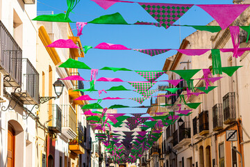 Fototapeta na wymiar Town street adorned with colored flags.