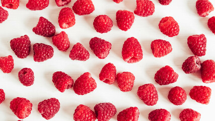 Fresh red raspberries on a white table background