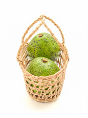 A basket of avocados on a white background