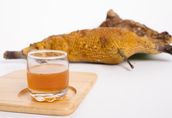 Fresh honey glass from honeycomb, with white bg