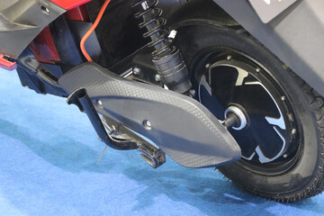 Electric scooter rear wheel with brushless dc motor connected along with a view of suspension spring