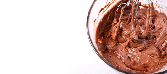 Web banner with chocolate dough prepared with mixer in the glass bowl on white background. Mockup...