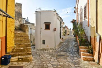 A narrow street between the old houses of Grottole, a village in the Basilicata region, Italy.
