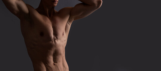 Fototapeta na wymiar Shirtless and bare-chested. Shirtless man grey background. Fit guy with muscular torso. Man sexy bare torso, banner with copy space.