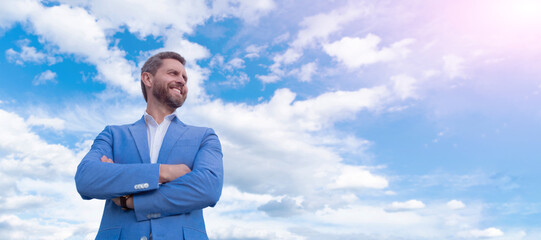 Man face portrait, banner with copy space. Business man in suit, blue sky background. professional...
