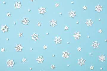 Winter pattern made of snowflakes on blue pastel background