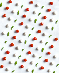 Pattern from tomatoes, basil and mozzarella on white background