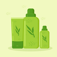 bottles and tubes with cosmetics is decorated with plants in green