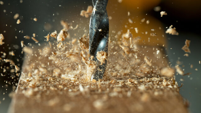 Super slow motion of a drill bit drilling into wood, macro shot
