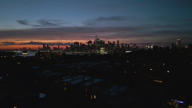 alt sunset view of NYC skyline flying backward revealing Brooklyn church