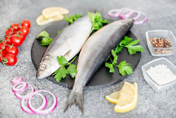 salted herring with red onion and parsley on stone background
