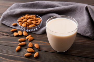Almond and almond milk on wooden table