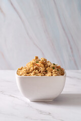 Chinese Asian Egg and Vegetable Fried Rice on a White table