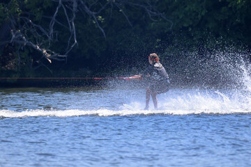 Waterskiier bouncing on water making huge waves