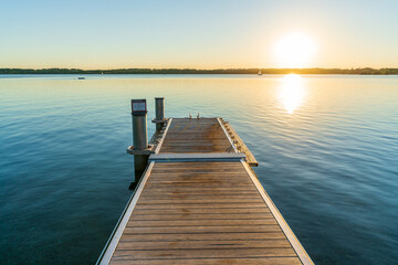 Naklejka premium A beautiful sunset behind a jetty at the Cospudener See in summer