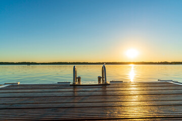 A beautiful sunset behind a jetty at the Cospudener See in summer