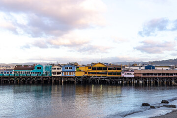 A view on restaurants and shops on pier with dramatic clouds