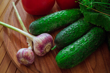 Fresh vegetables on a wooden table. Greens and dill for pickling vegetables.