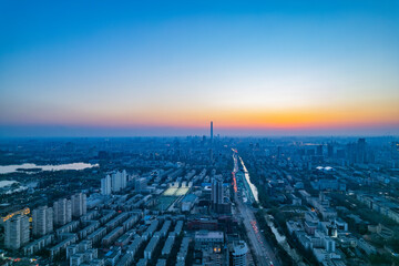 Naklejka na ściany i meble Aerial shot of city high-rise in the evening