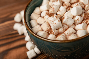 Cup of tasty cocoa drink and marshmallows in blue cup.Spices and marshmallows for winter drinks on...