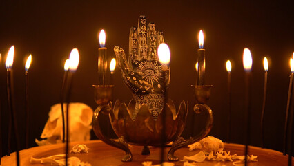 Magic and occult attributes on the table, pagan magic symbols background. Blowing black witchcraft...