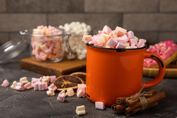 Cocoa drink on texture background. Hot chocolate with small marshmallows and spices. Winter warming drink concept. Space for copy. Space for text