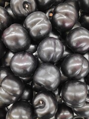 A bunch of fresh and healthy black plums