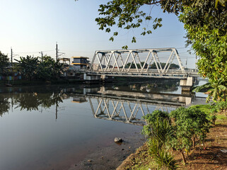 morning river view in jakarta indonesia with railway over the river