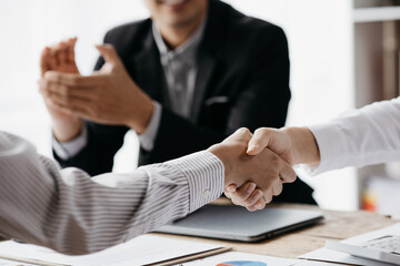 Business investor group holding hands, Two businessmen are agreeing on business together and shaking hands after a successful negotiation. Handshaking is a Western greeting or congratulation.