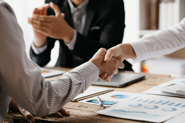Business investor group holding hands, Two businessmen are agreeing on business together and shaking hands after a successful negotiation. Handshaking is a Western greeting or congratulation.