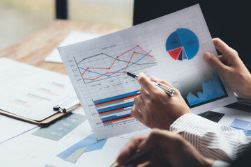 The sales department is having a monthly summary meeting to bring it to the department manager, they are verifying the correctness of the documents that are prepared before bringing in to the manager