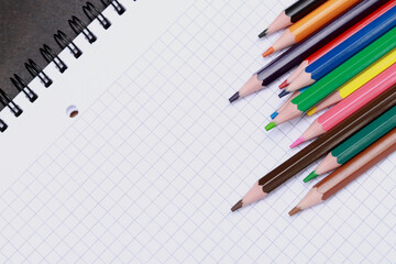 Colored pencils on a notebook. Background for making your text. Business, education or study