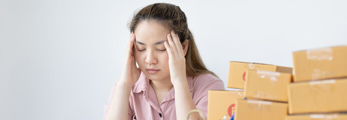 Young woman sitting on a desk is sad or depressed about a sales business, Anxiety and...