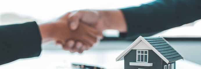 Business success, Real estate agents and customers shake hands to congratulate after signing a contract to buy a house with land and insurance, handshake and Good response concept.