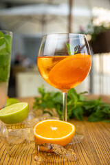 alcoholic cocktail with ice, orange, mint
