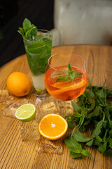 alcoholic cocktail with ice, orange, mint

