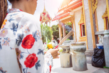 Beautiful Asian girl at big Buddhist temple dressed in traditional costume