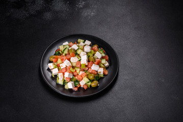 Greek salad with juicy tomatoes, feta cheese, lettuce, green olives, cucumber, red onion and fresh parsley