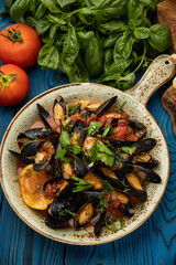 delicious seafood stew with mussels on wooden table
