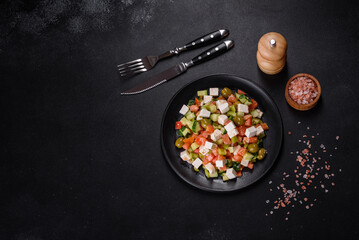 Greek salad with juicy tomatoes, feta cheese, lettuce, green olives, cucumber, red onion and fresh parsley