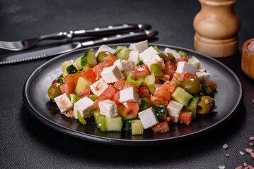 Greek salad with juicy tomatoes, feta cheese, lettuce, green olives, cucumber, red onion and fresh parsley