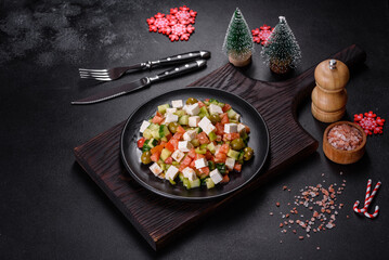Greek salad with juicy tomatoes, feta cheese, lettuce, green olives, cucumber, red onion and fresh parsley