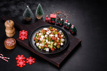 Greek salad with juicy tomatoes, feta cheese, lettuce, green olives, cucumber, red onion and fresh parsley