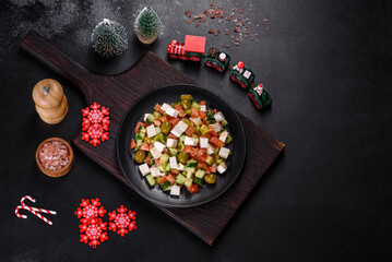 Greek salad with juicy tomatoes, feta cheese, lettuce, green olives, cucumber, red onion and fresh parsley