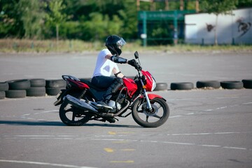 Obraz na płótnie Canvas Moto school track driving. A biker on a motorcycle. 