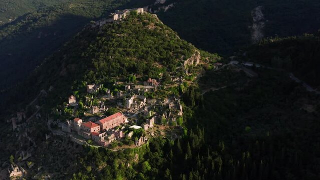 Drone shot of medieval old city of Mystras with Monastery of Pantanassa, Temple of Agia Sofia and uphill castle of Mystras, Sparta, Peloponnese, Greece