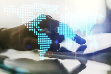 Abstract creative world map and finger clicks on a digital tablet on background, international trading concept. Multiexposure