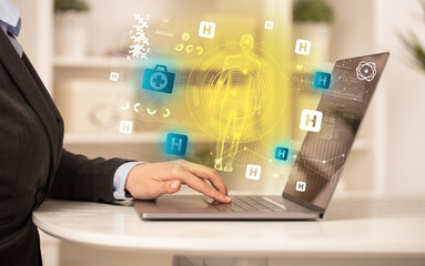 Doctor working on laptop with healthcare concept