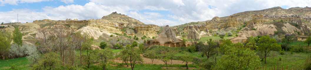 Panoramic landscape of Mustafapasa village in summer time, hills, farming, trees and nature of Cappadocia, Urgup, Nevsehir, Turkey. 